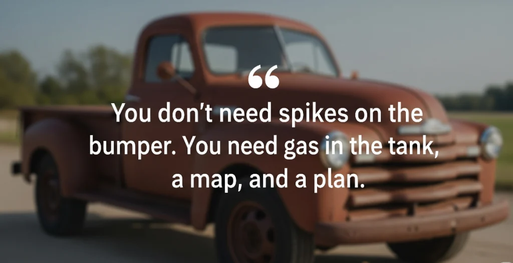 A pullquote featuring the text "You don’t need spikes on the bumper. You need gas in the tank, a map, and a plan." in white text, set against a blurred background of a rusty, vintage brown pickup truck.